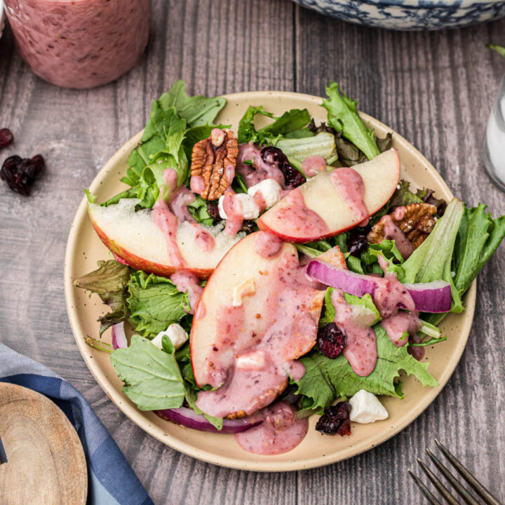 thanksgiving salad on plate with cranberry vinaigrette dressing