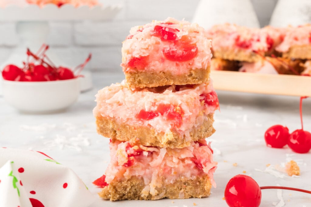 cherry coconut bars stacked on top of each other