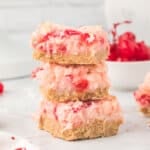 three cherry coconut magic bars stacked