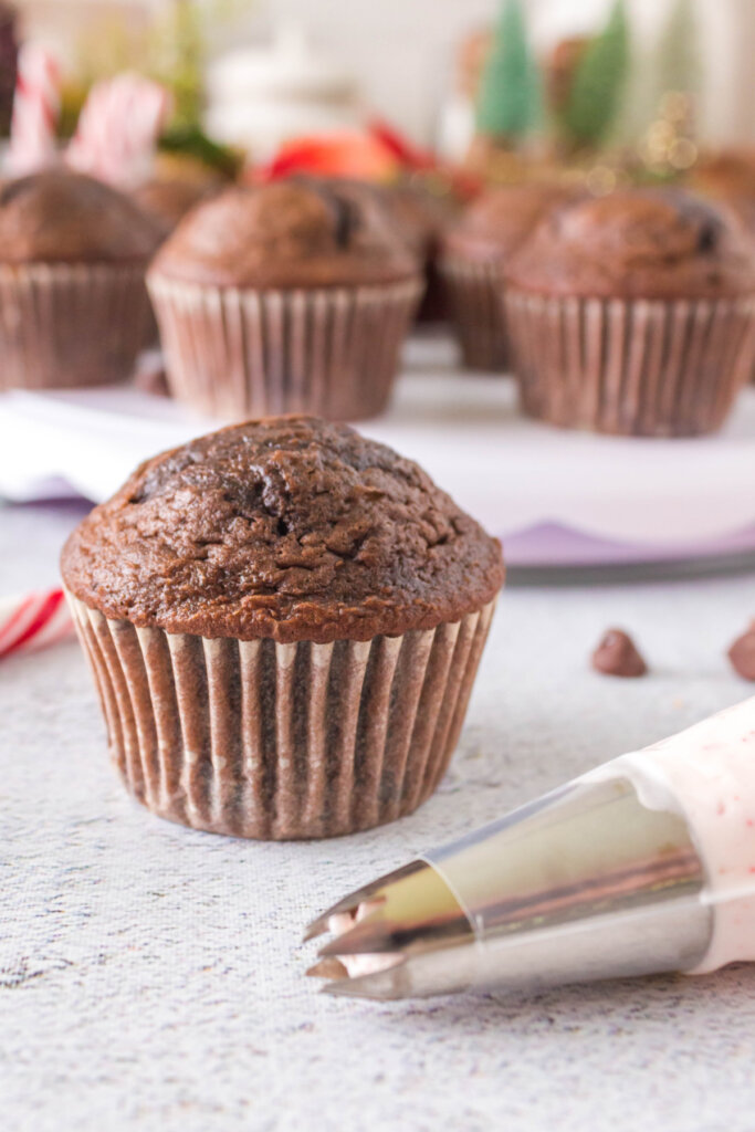 doctored-up chocolate cake mix cupcake getting ready to frost