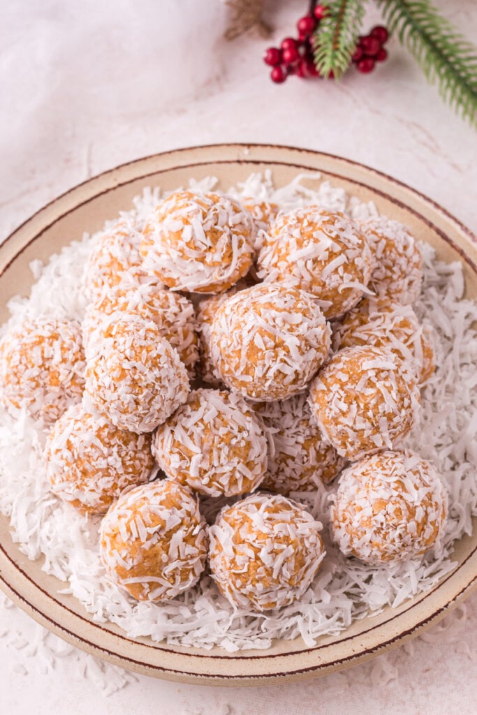 closeup of finished coconut snowballs stacked on plate