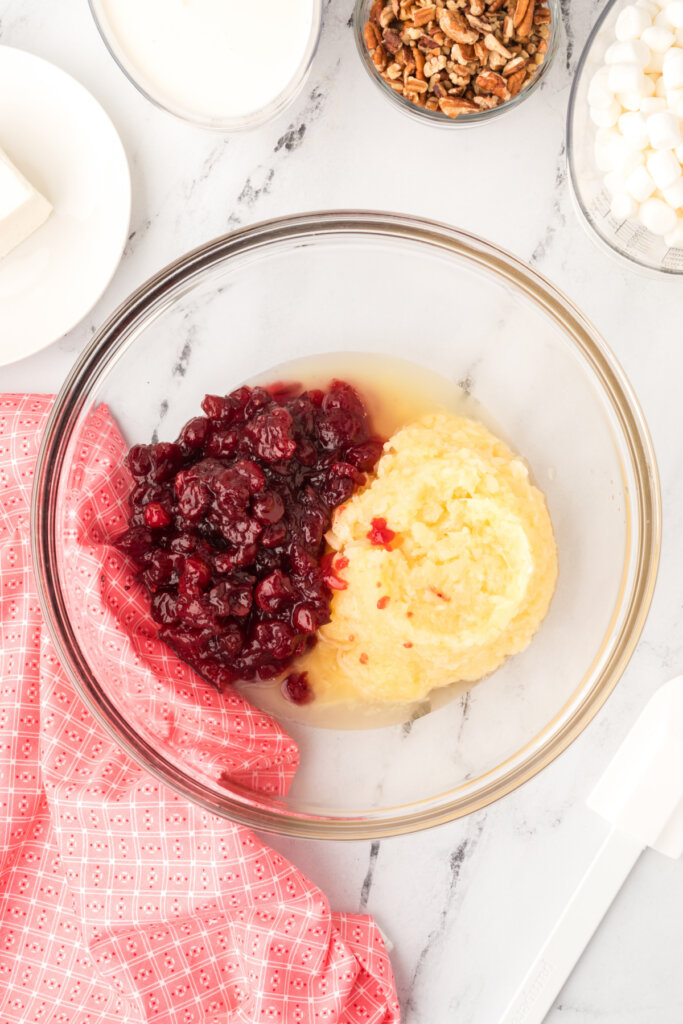 place the cranberry auce and pineapple in a large bowl