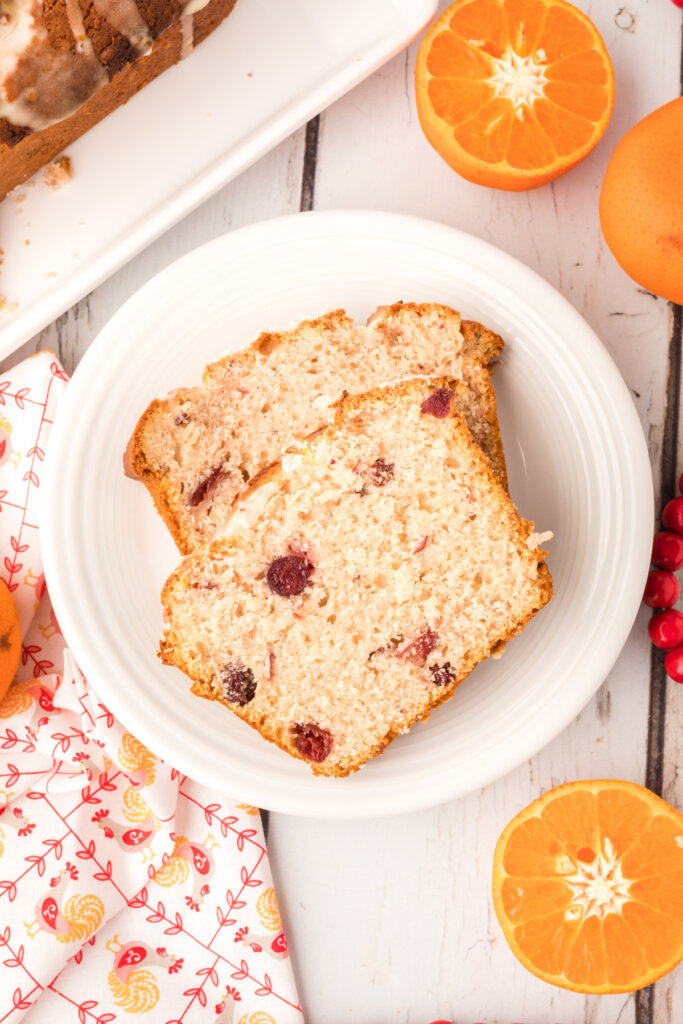 two slices of orange cranberry bread on white plate