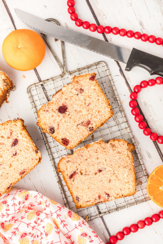 slices of orange cranberry bread on small cooling rack
