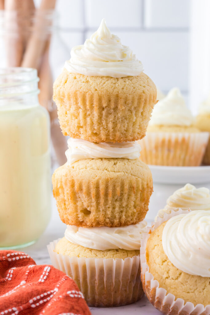 three frosted eggnog cupcakes stacked