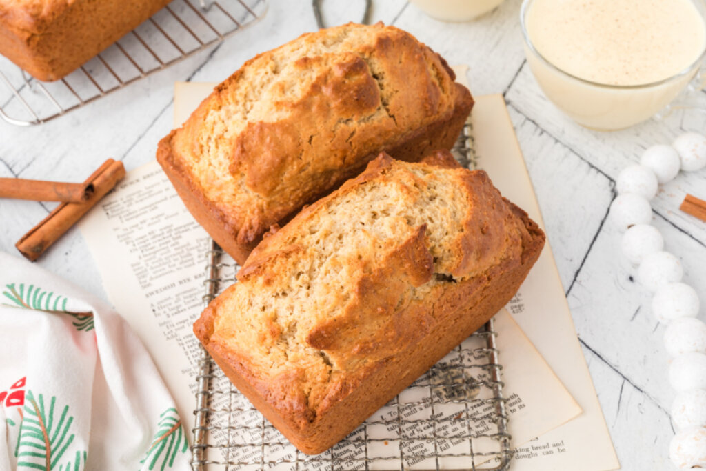 two loaves of finihsed eggnog bread on cooling rack