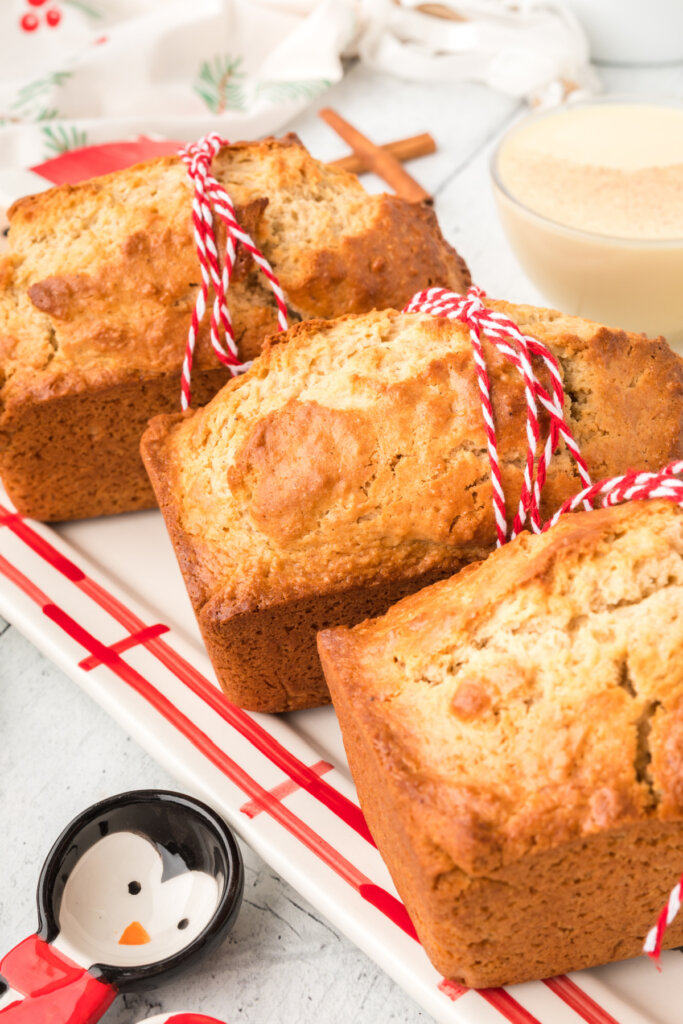 three loaves of eggnog bread lined up on towel