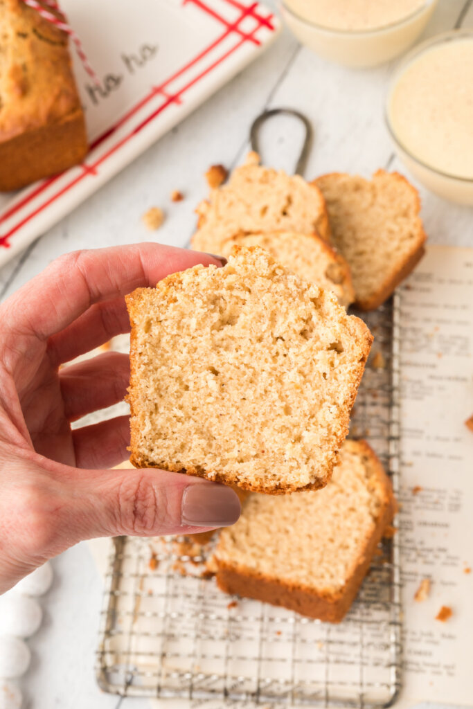 hand holding slice of holiday eggnog bread