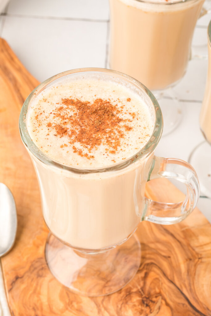 ground nutmeg sprinkled over the top of a glass with hot buttered rum