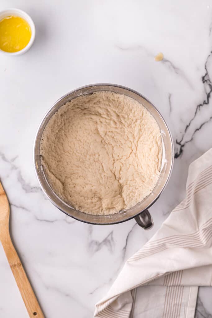 Risen dough in a mixing bowl for homemade Texas Roadhouse rolls