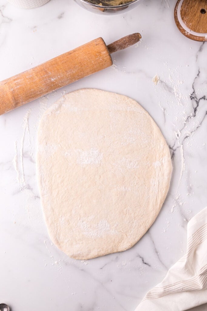 Texas Roadhouse roll dough rolled out on a floured work surface