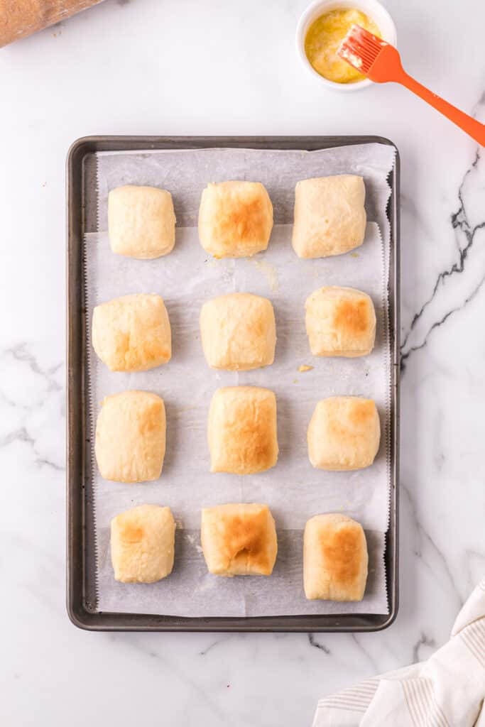 Freshly baked Texas Roadhouse rolls on a baking sheet