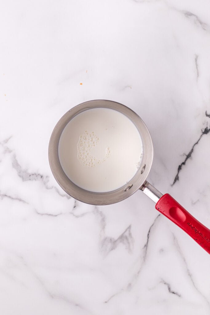 Milk warming in a saucepan for homemade Texas Roadhouse rolls