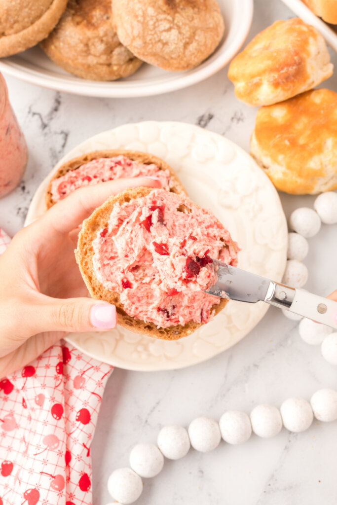 cranberry butter spread over the top of a toasted english muffin