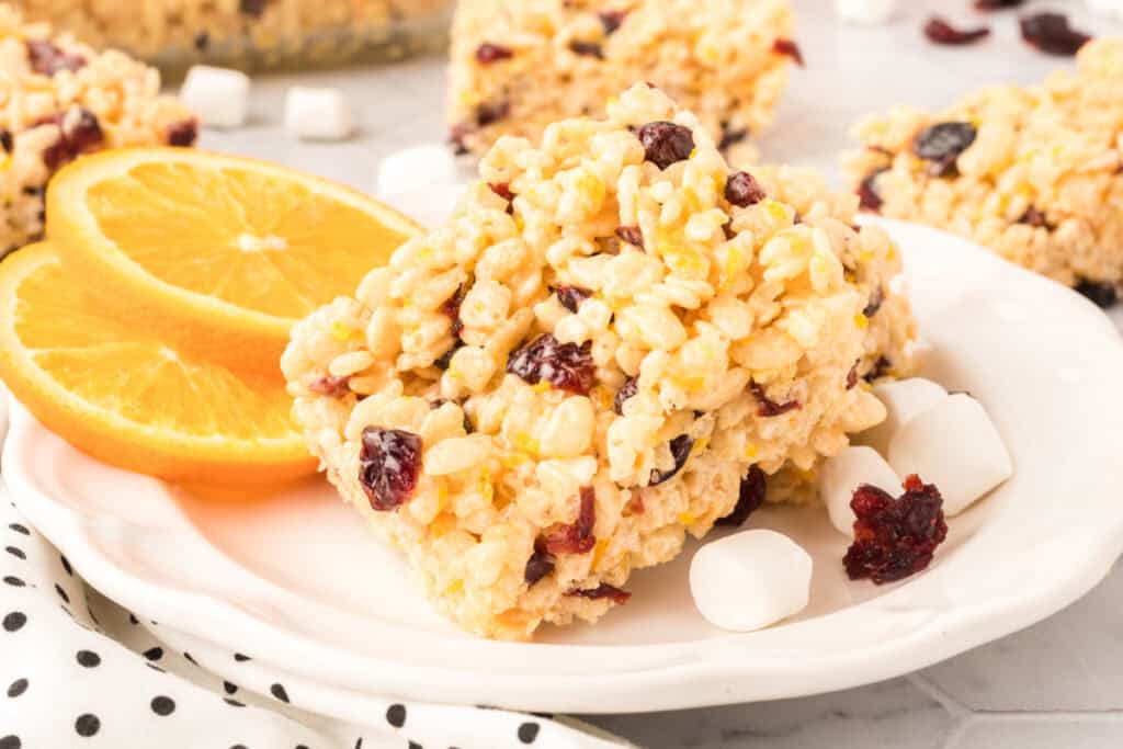 Close-up of stacked cranberry orange crispy treats showing crisp rice cereal, dried cranberries, and orange zest.