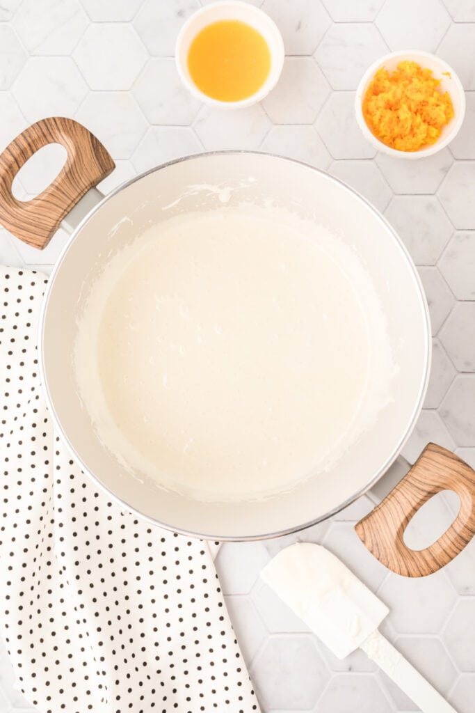Smooth melted marshmallow mixture in a saucepan before adding the orange flavoring.