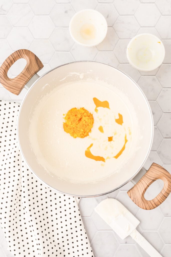 Orange zest and orange juice added to the melted marshmallow mixture for cranberry orange crispy treats.