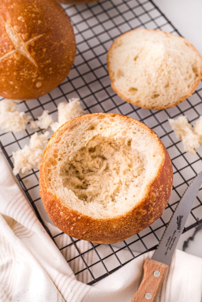 bread bowl on cooling rack with top off and hollowed out