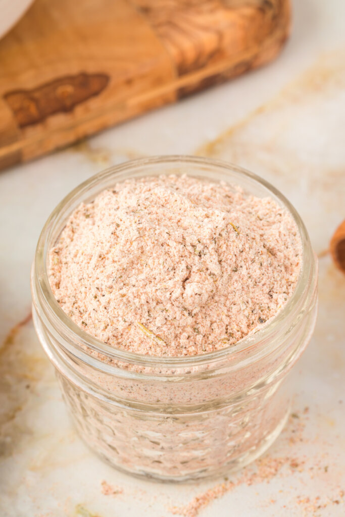 looking down into a glass jar with homemade beef stew seasoning mix