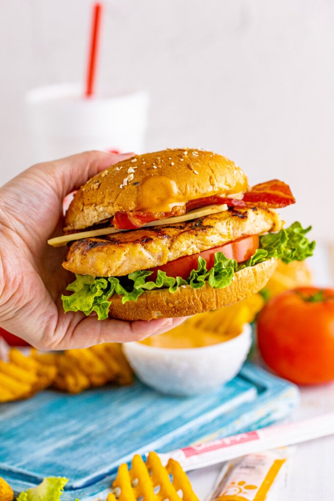 hand holding copycat chick-fil-a grilled chicken club