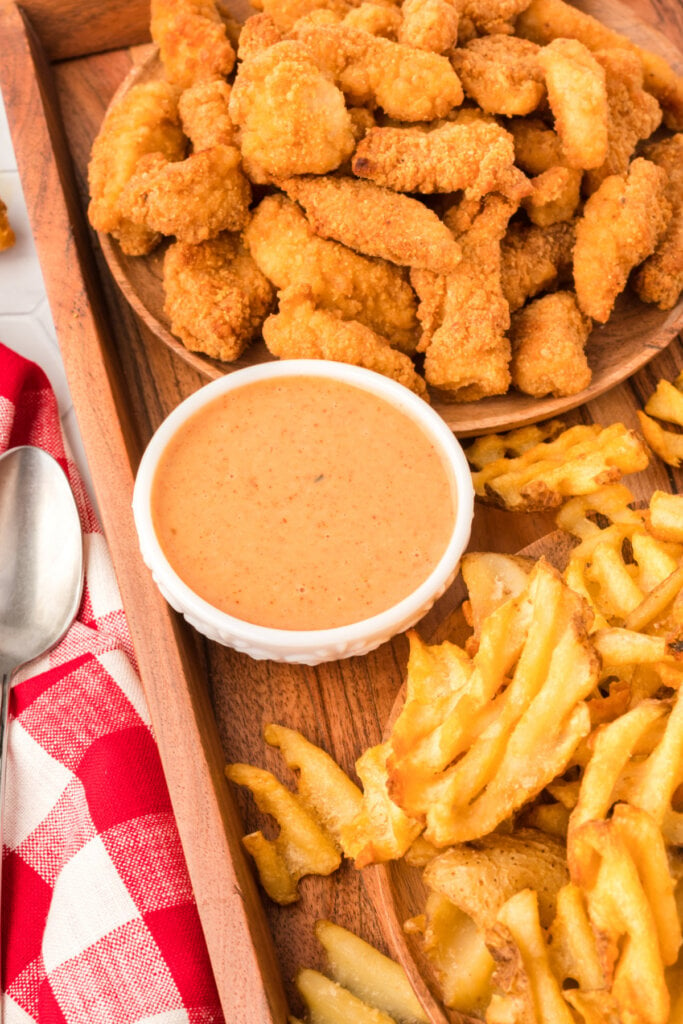 serving platter with chicken pieces, waffle fries, and honey roasted bbq sauce