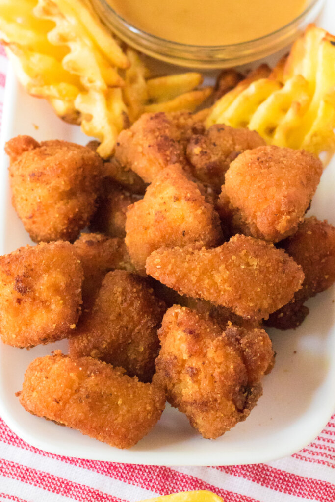 copycat chick-fil-a nuggets on plate with waffle fries
