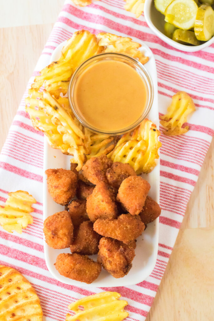 copycat chick-fil-a nuggets on plate with waffle fries and dipping sauce