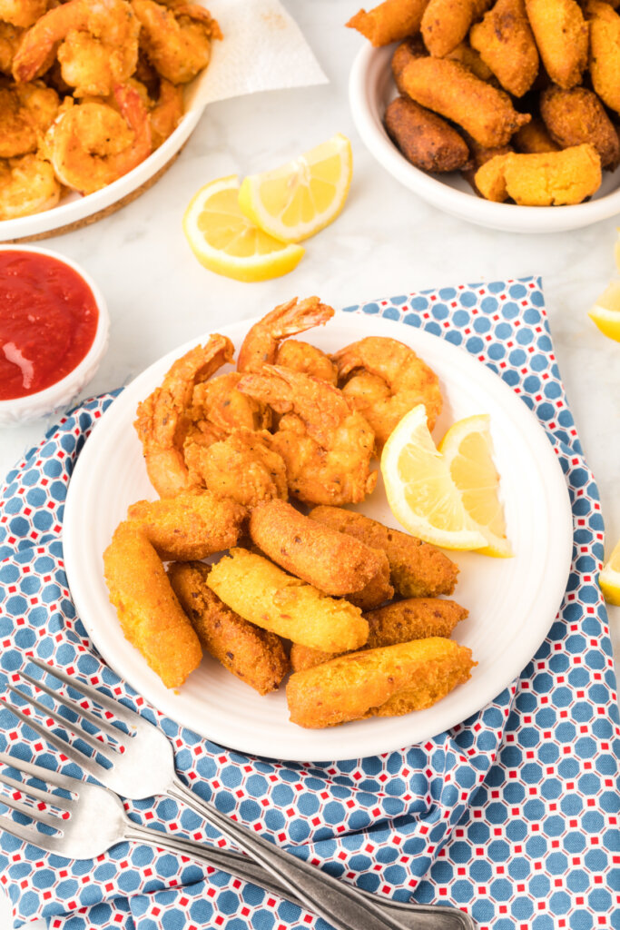 looking down onto a plate with shrimp and hush puppies