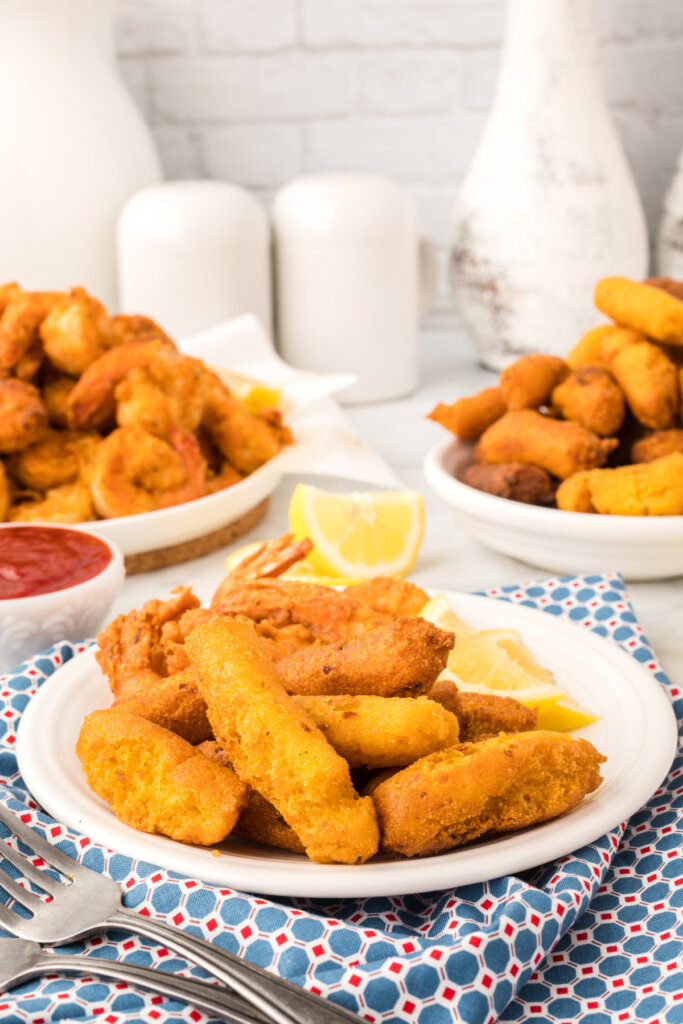 hush puppies on a plate in front of shrimp