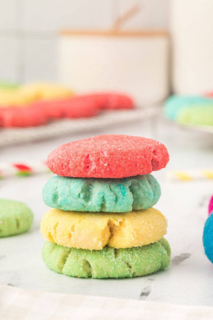 a red, blue, yellow, and green jello cookie stacked on top of each other