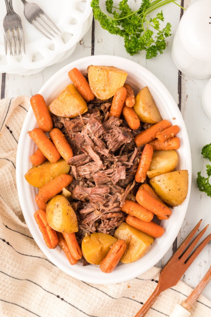 serving platter with pot roast, potatoes, and carrots