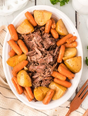 pot roast with carrots and potatoes on platter