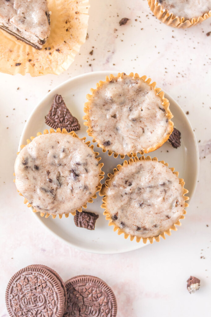 three oreo cheesecake cupcakes on white plate