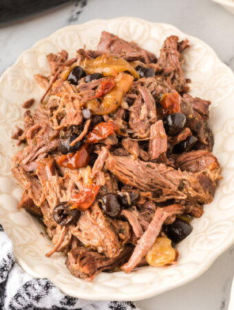 shredded slow cooker mediterranean pot roast on platter