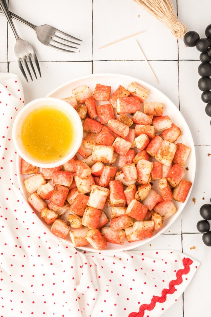 air fryer crab bites on serving plate with garlic butter dipping sauce