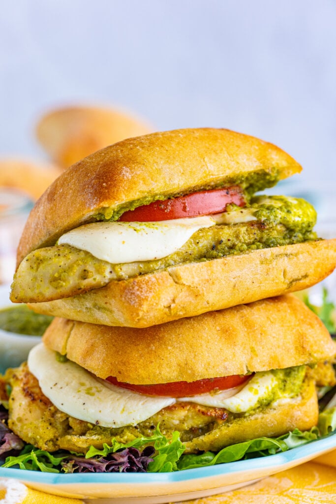 two toasted pesto chicken sandwiches stacked