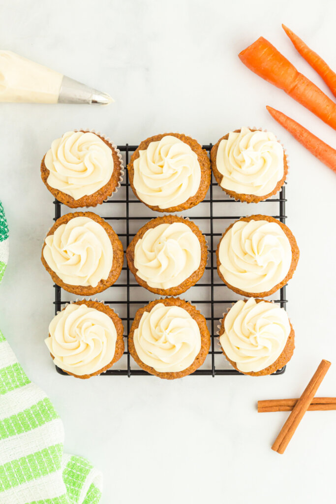 looking down onto nine frosted cupcakes on a wire rack