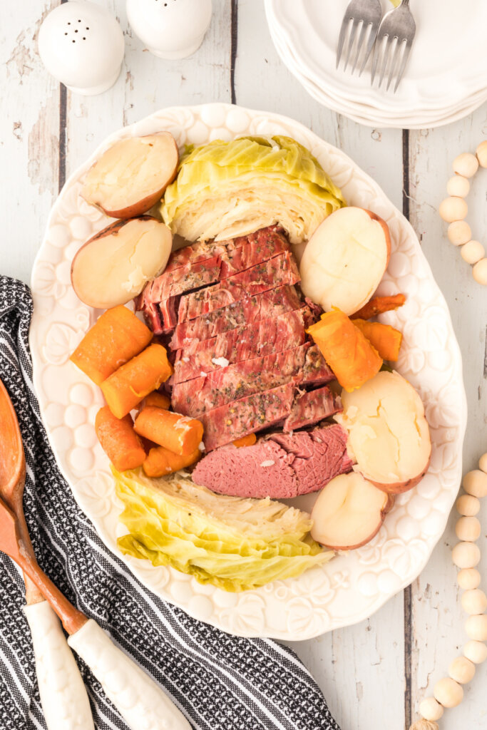 corned beef and cabbage on platter with carrots and potatoes