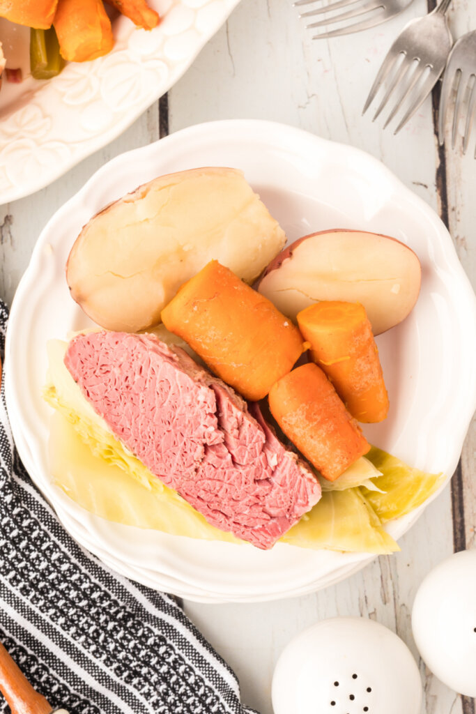 corned beef, cabbage, potatoes, adn carrots on plate