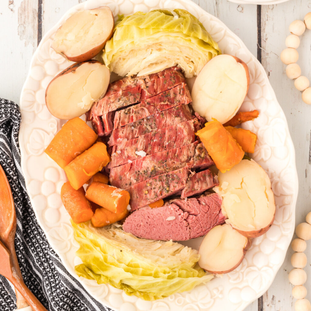 looking down onto a platter with corned beef, cabbage, potatoes, and carrots