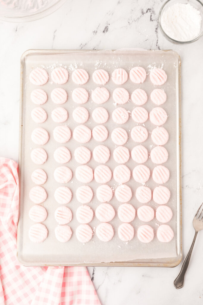 cream cheese mints drying on a baking sheet