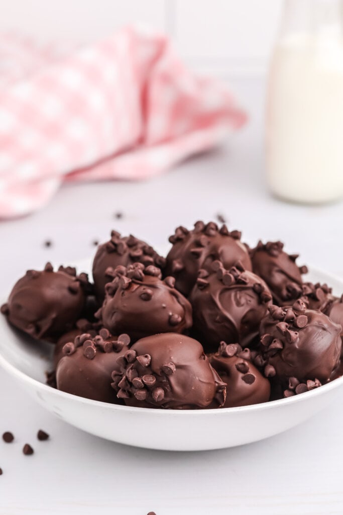 no bake brownie bites in bowl with pink checkered napkin in background