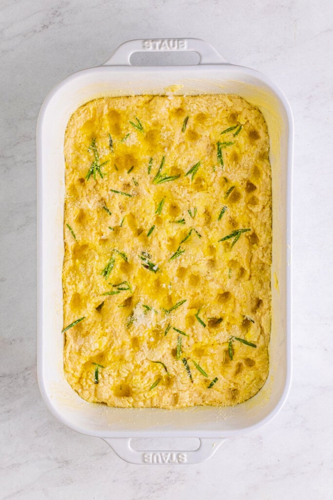 unbaked rosemary focaccia in pan