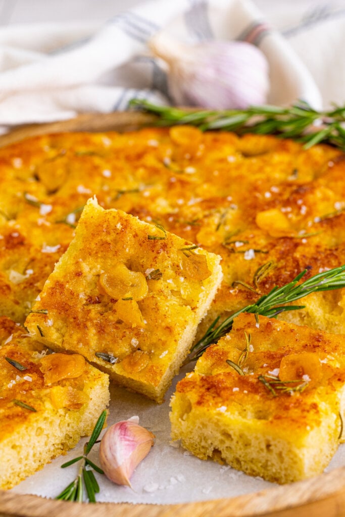 closeup of piece of focaccia bread with the loaf