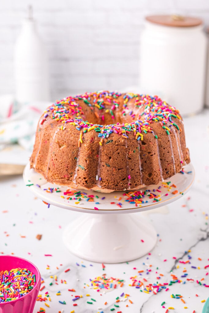 whole funfetti pound cake on cake stand