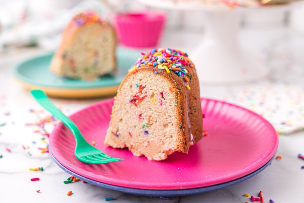 slice of funfetti pound cake on pink plate