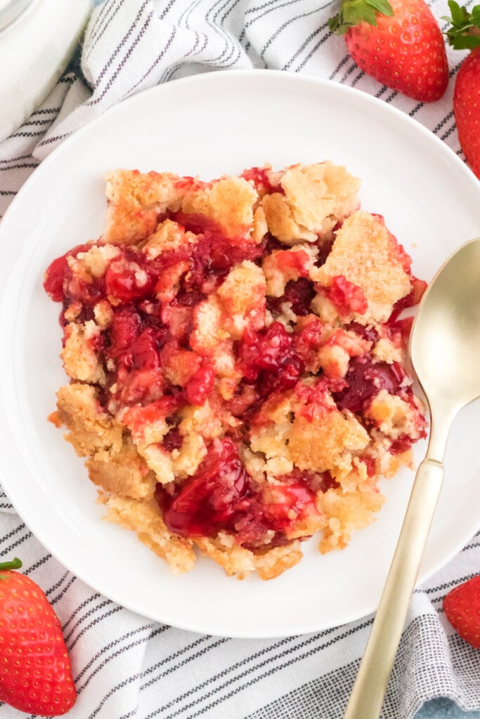 strawberry dump cake on white plate