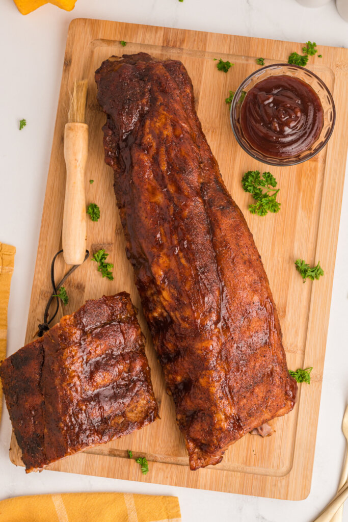 full slab of oven baked ribs on cutting board