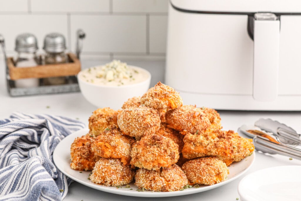 buffalo chicken poppers stacked on a serving plate