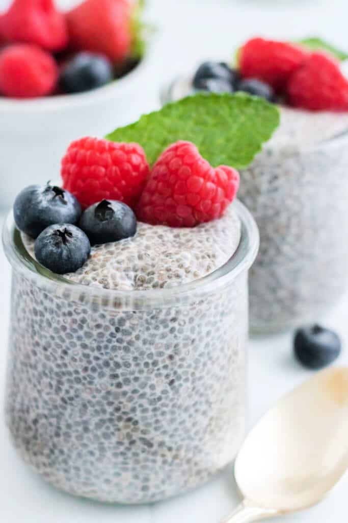 closeup of two jars with chia seed pudding